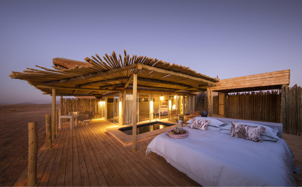 Inspired by Dead Vlei, the design of the 10 luxury desert suites has been cleverly expanded to offer improved airflow, and the use of brick and glass, and a thatch roof, further enhances temperature control. The interior décor echoes the natural beauty of the surrounding desert, replicated in the colour palette and featured art.⁠